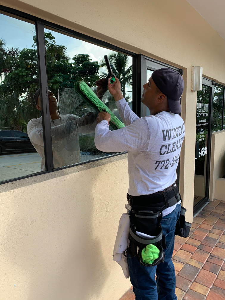 Commercial window cleaner cleaning windows in Stuart, Florida